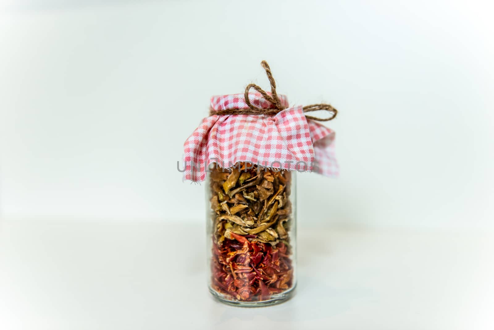 jar of dried spices. Red and green peppers in a glass jar. Grandma's blanks