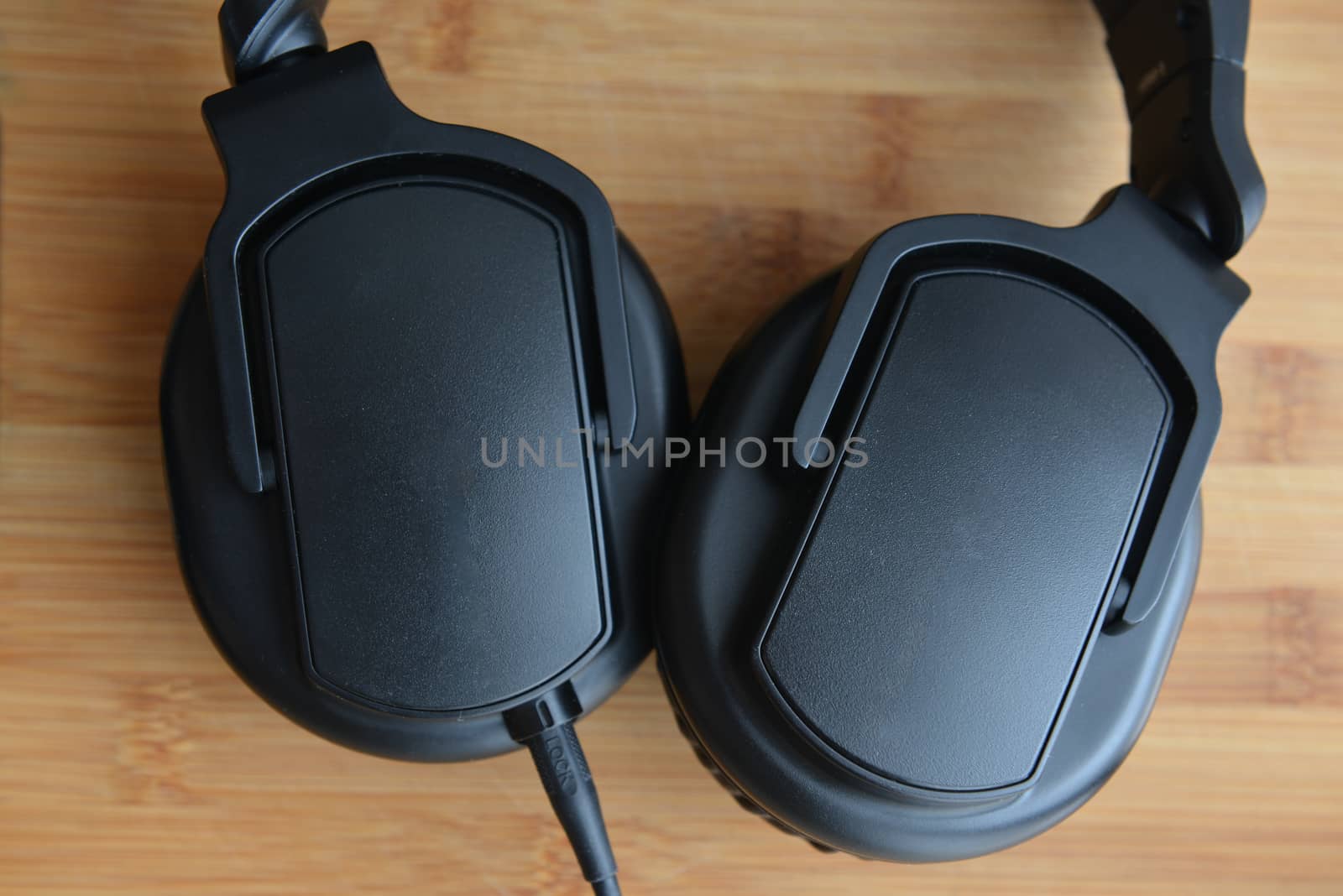 Black big headphones monitor on wooden background by marynkin