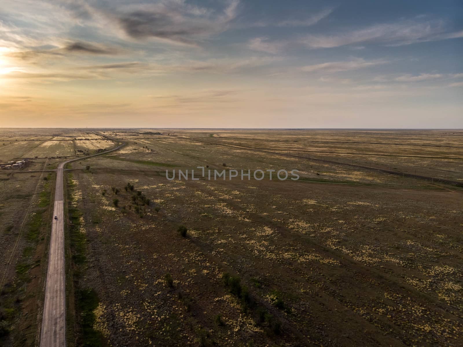 Empty asphalt road goes into the distance on sunset by marynkin