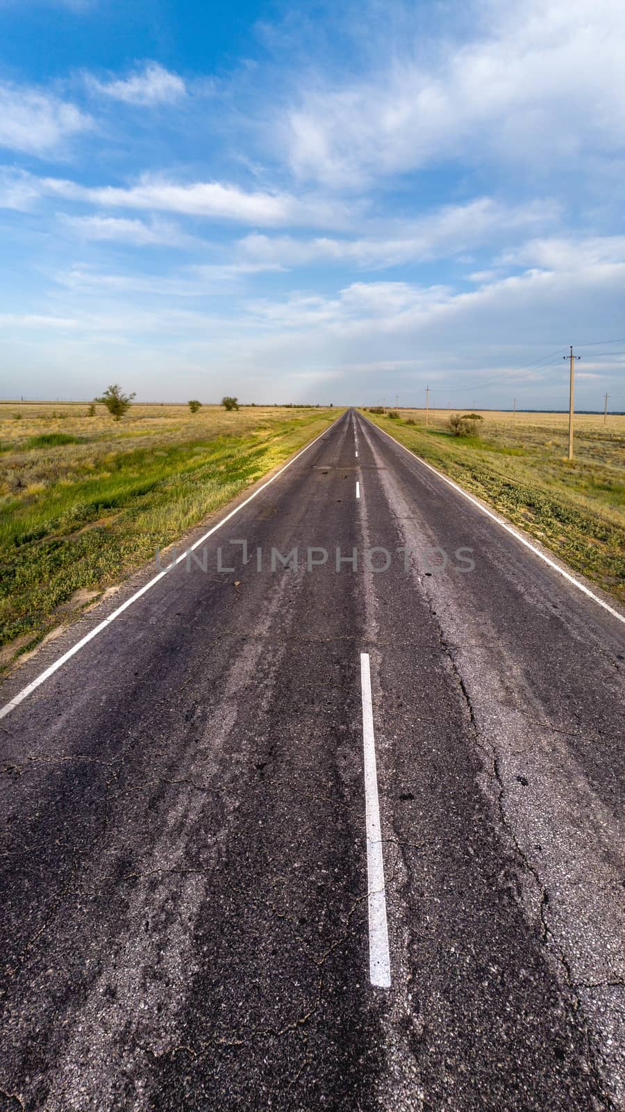 Empty asphalt road goes into the distance.