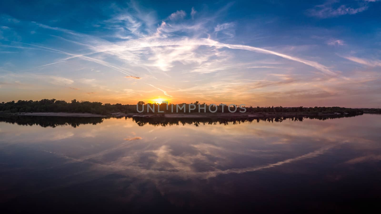 Beautiful landscape with reflection, blue sky and yellow sunlight in sunrise. Amazing scene reminiscent of the eye
