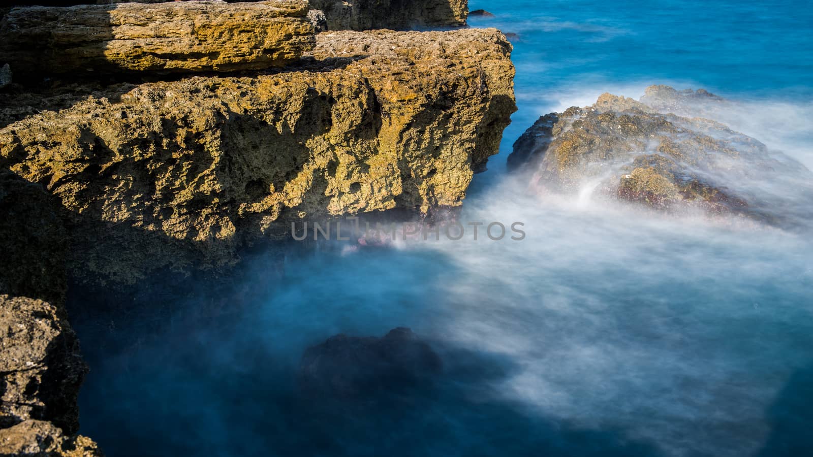 Sea waves are beating against the rocky shore by marynkin