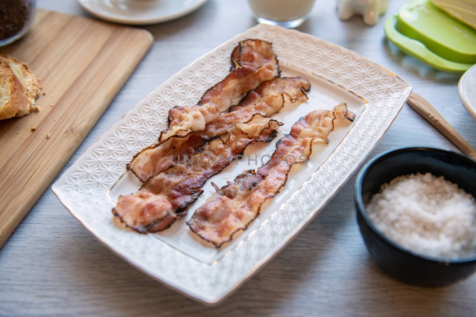 Fried bacon on white plate. Fat breakfast by marynkin