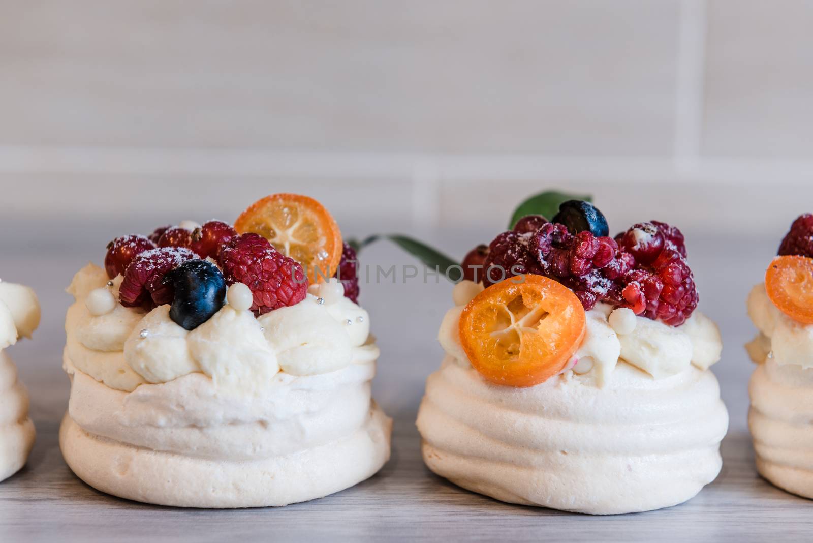 Pavlova meringue desert cake with cream and small fruits