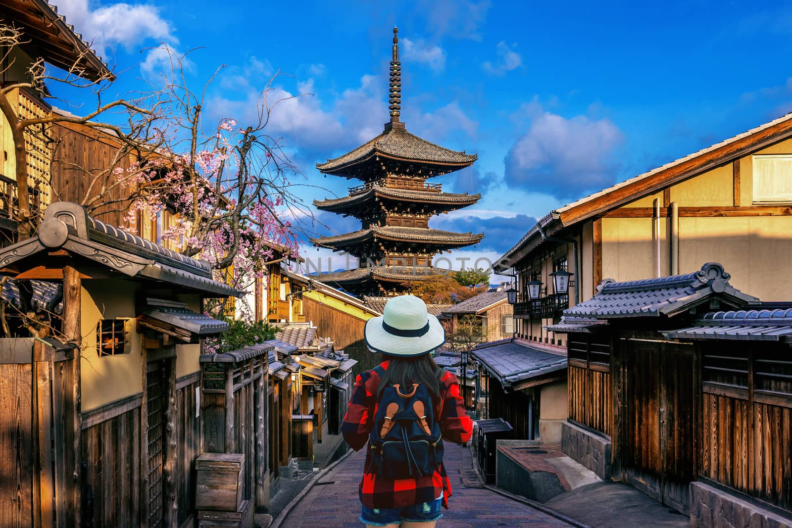 Woman traveler with backpack walking at Yasaka Pagoda and Sannen Zaka Street in Kyoto, Japan.