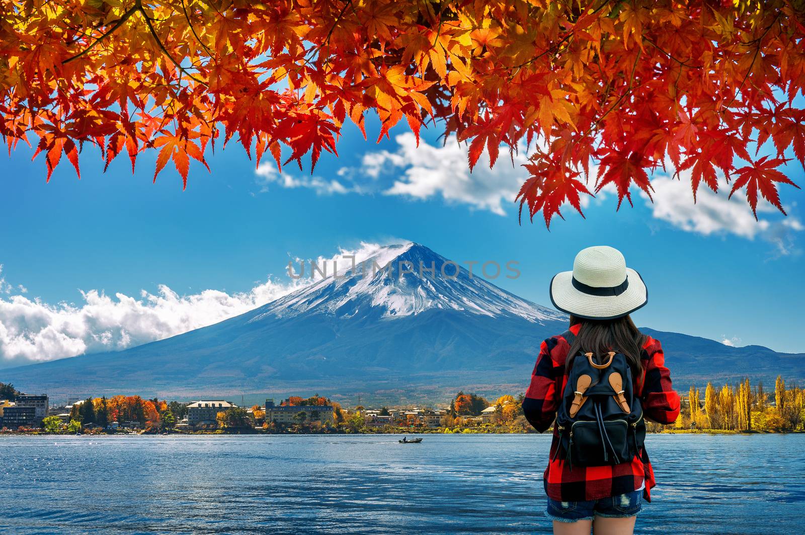 Woman traveler with backpack looking to Fuji mountains in Autumn, Japan. by gutarphotoghaphy