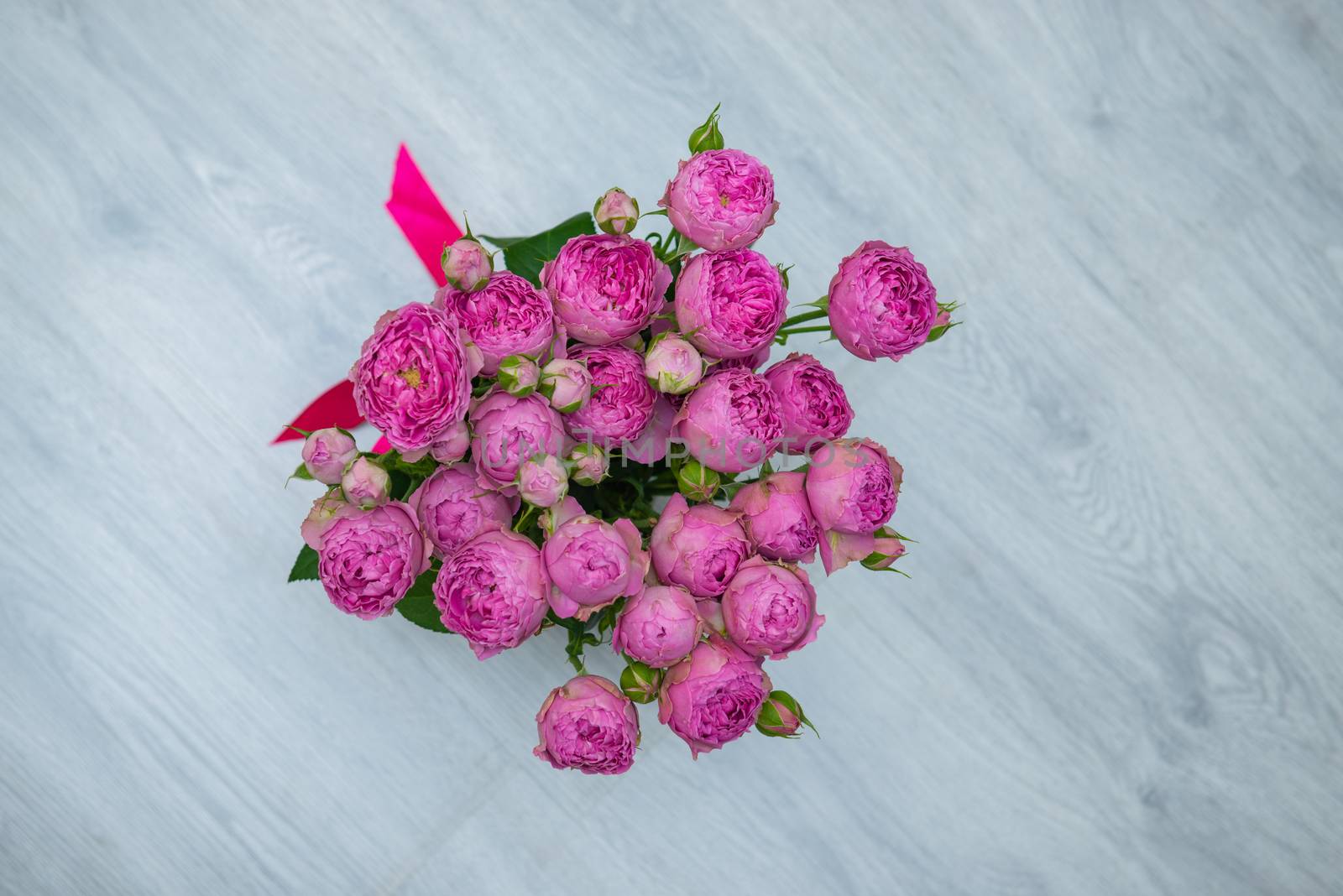 Garden flowers over grey wooden table background. Backdrop with copy space by marynkin