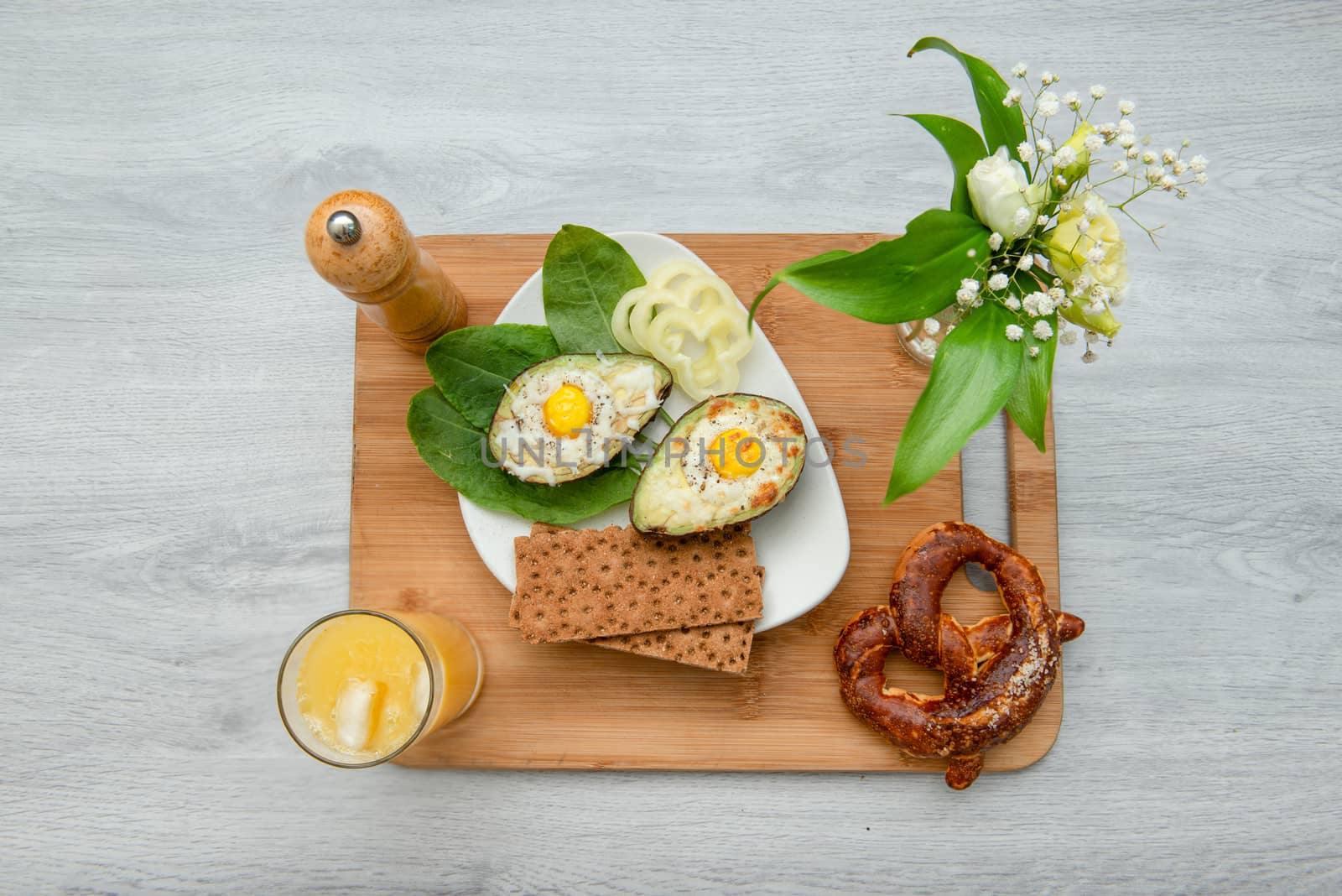 Eggs baked in avocado on plate by marynkin