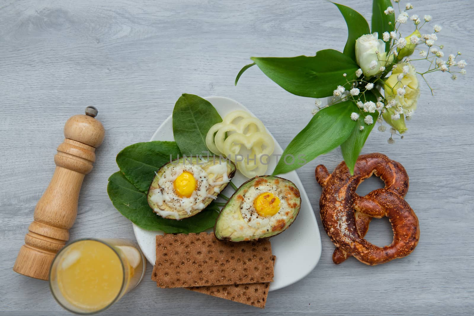 Eggs baked in avocado on plate by marynkin