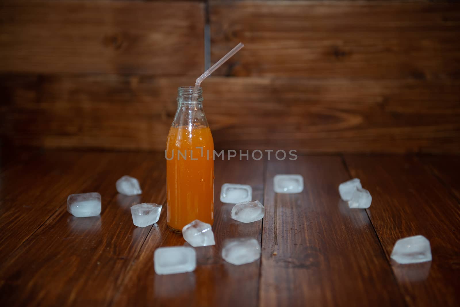 Ice fresh juice with ice cubes on table by marynkin