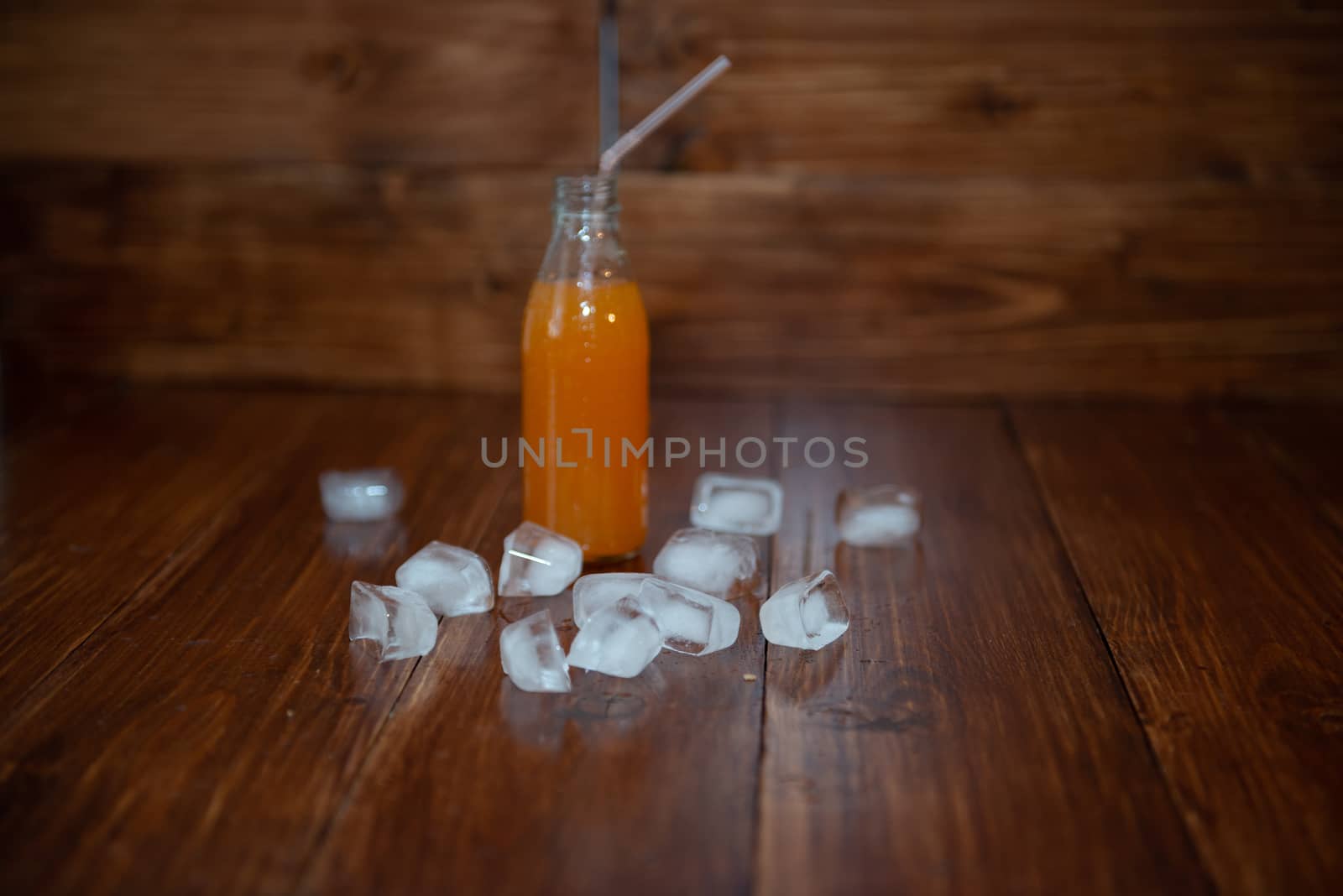 Ice fresh juice with ice cubes on table by marynkin