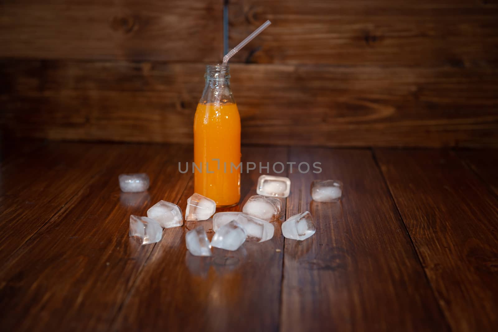 Ice fresh juice with ice cubes on table by marynkin