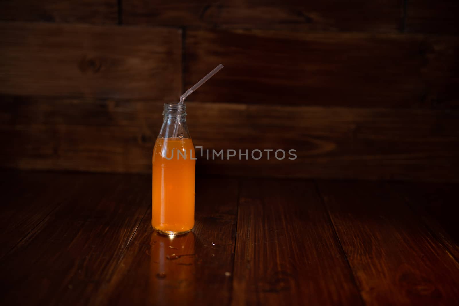 vintage bottle with juice and straw by marynkin