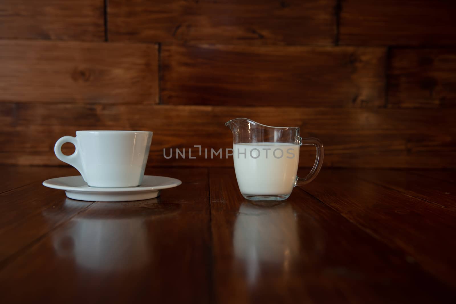 milk in glass milk jug with white cup by marynkin