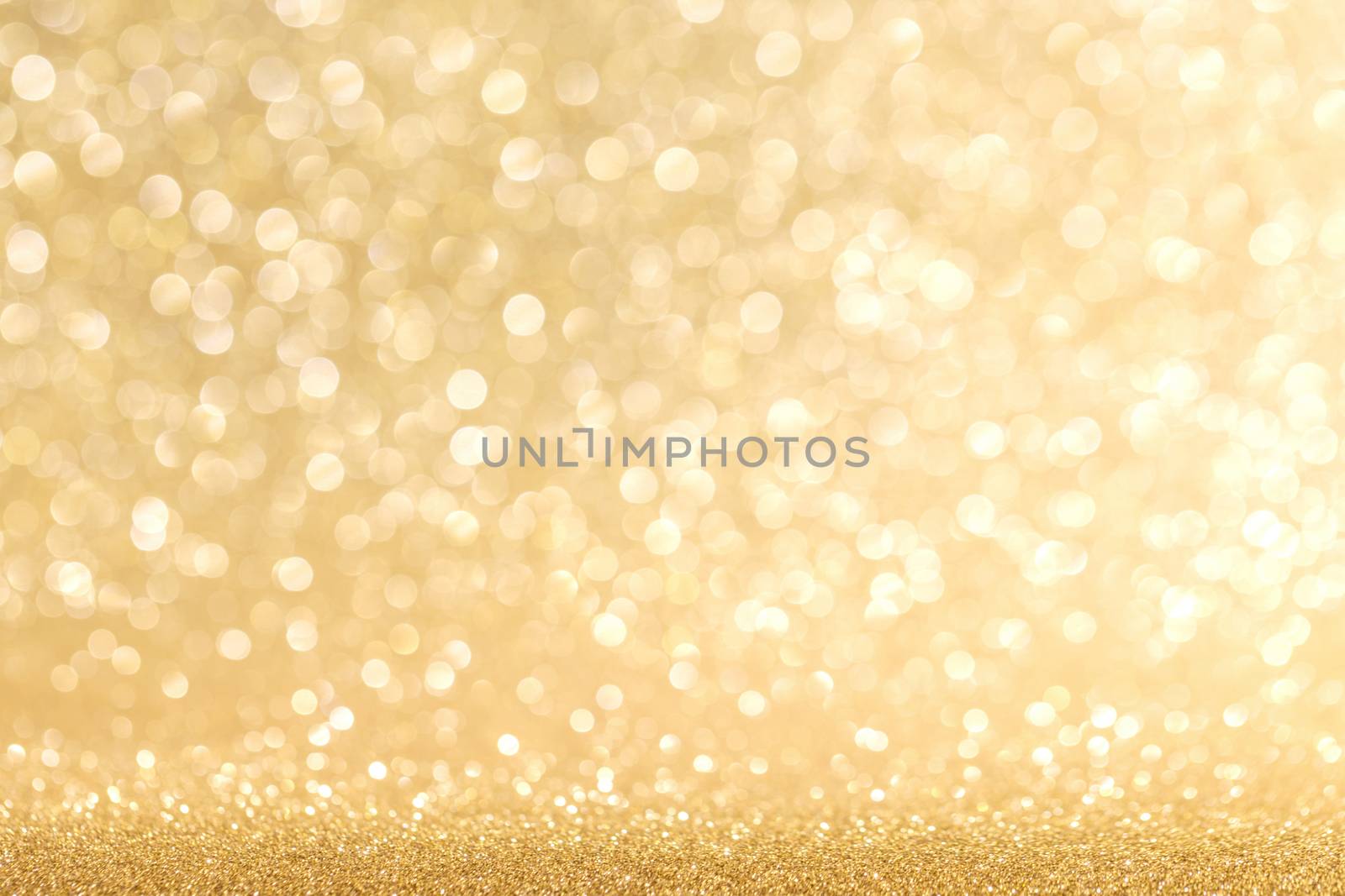 Golden festive glitter background with defocused lights