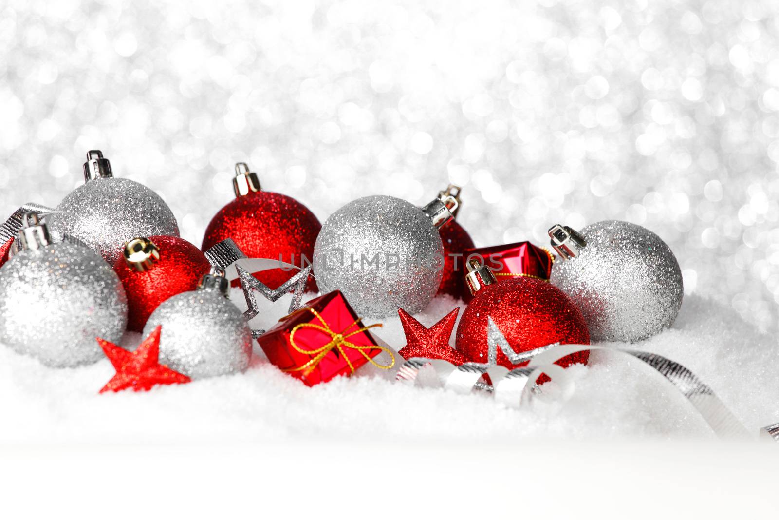 Red and silver christmas balls and decoration on snow