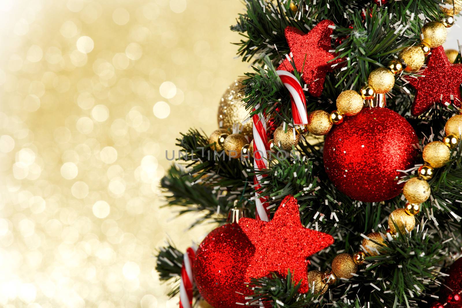 Beautiful christmas tree decorated with baubles and candies