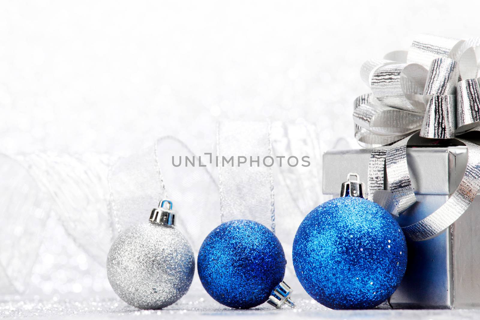 Christmas card with gift and decorative balls close-up