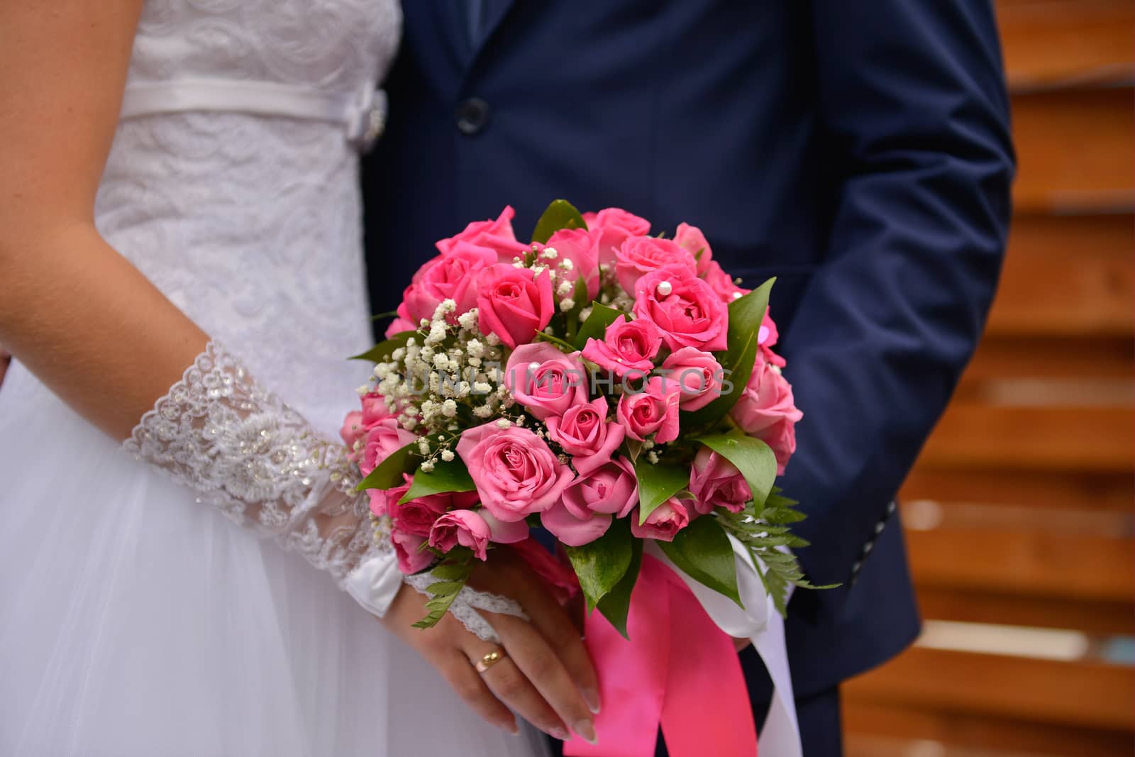 nice wedding bouquet in bride's hand. Kiss across bouquet