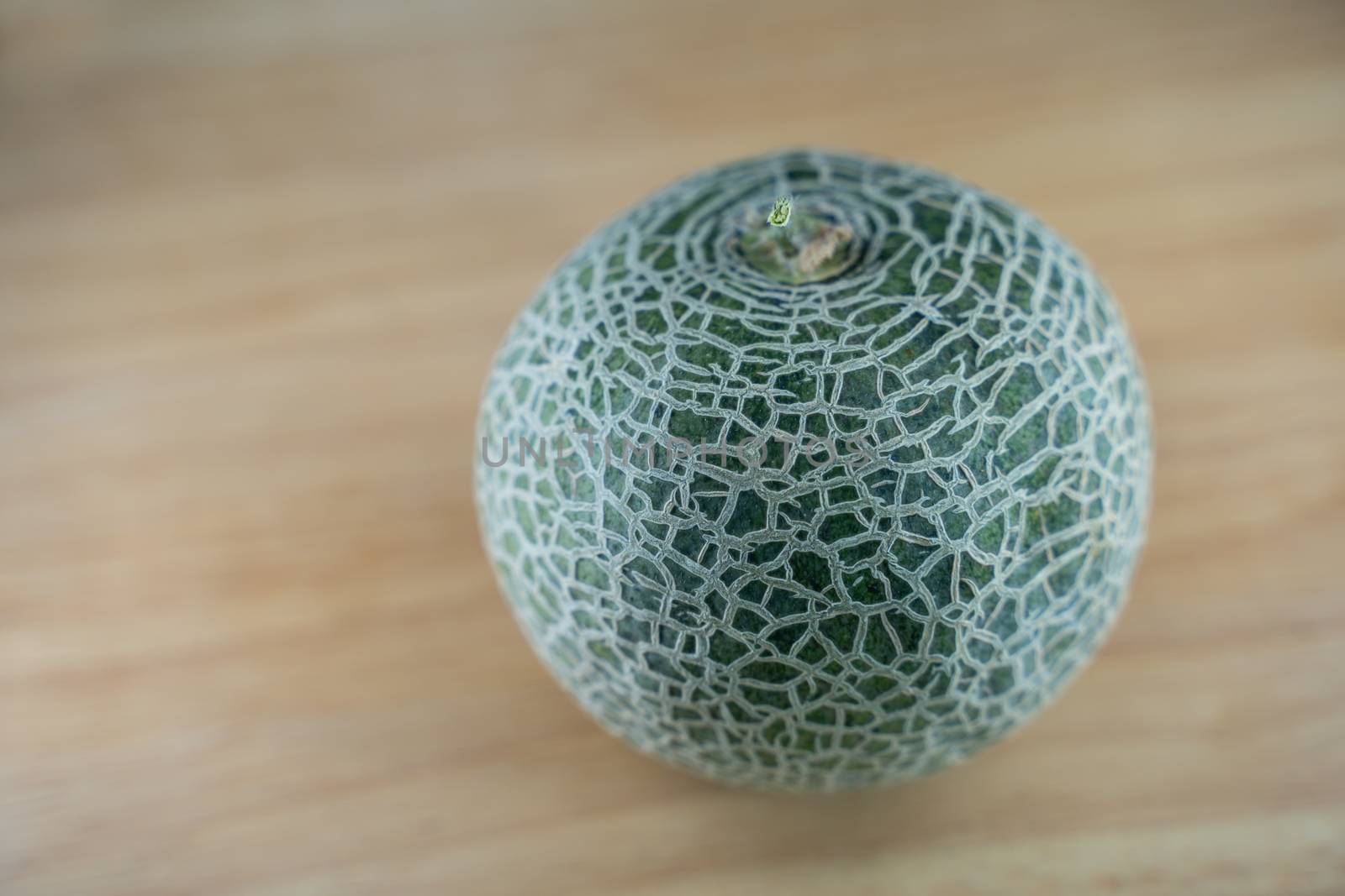 selected focus of A fresh green Melon on wooden background