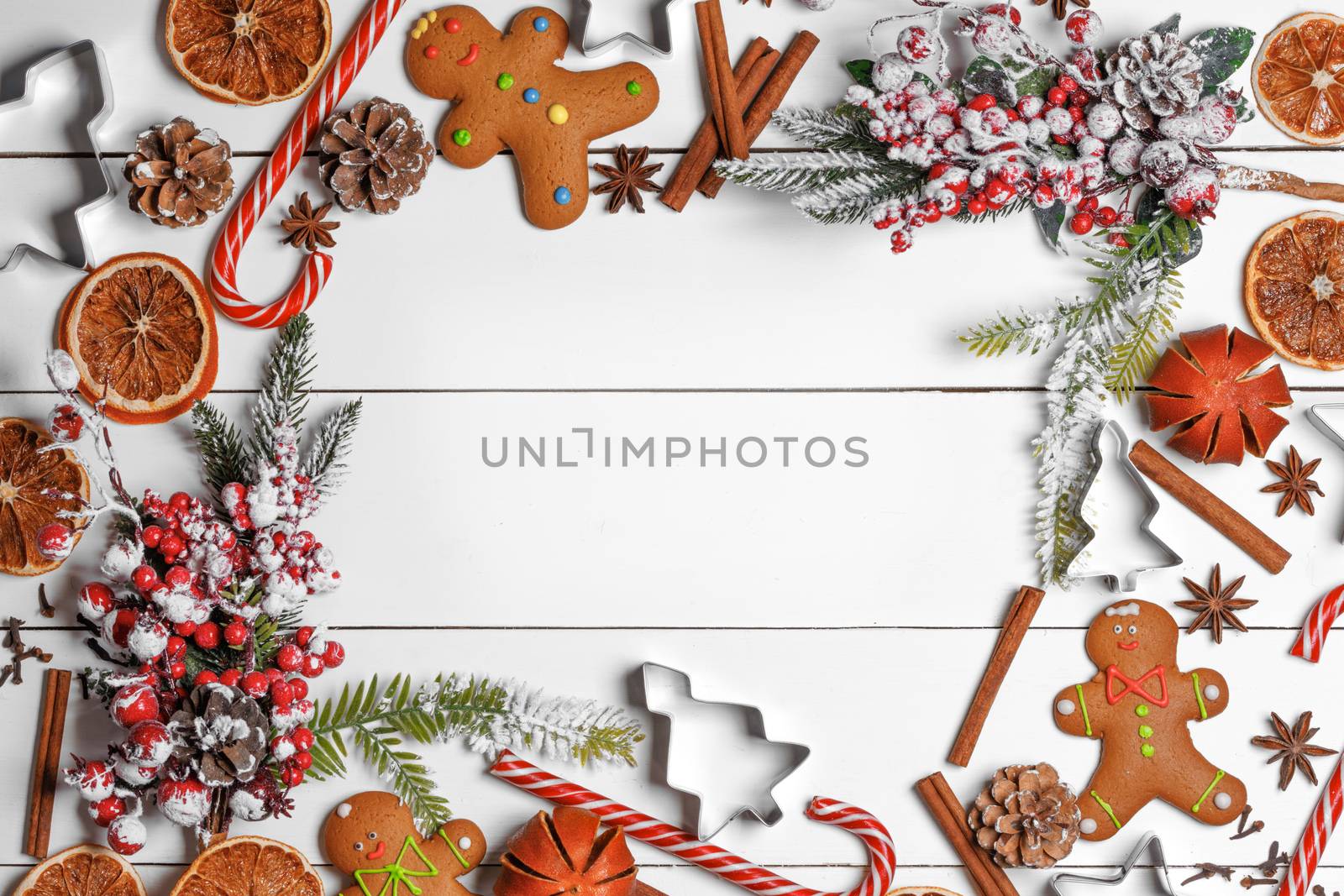 Christmas food frame. Gingerbread cookies, spices and decorations on white table background with copy space