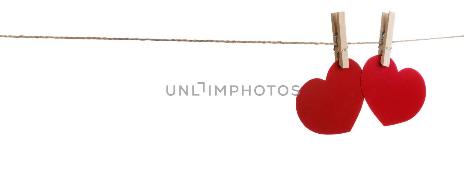 Two red paper hearts pinned together isolated on white background