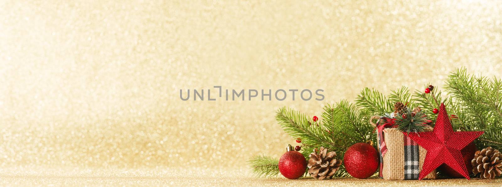 Christmas toys, decorations, present gift box wrapped in kraft paper on golden glitter background, copy space