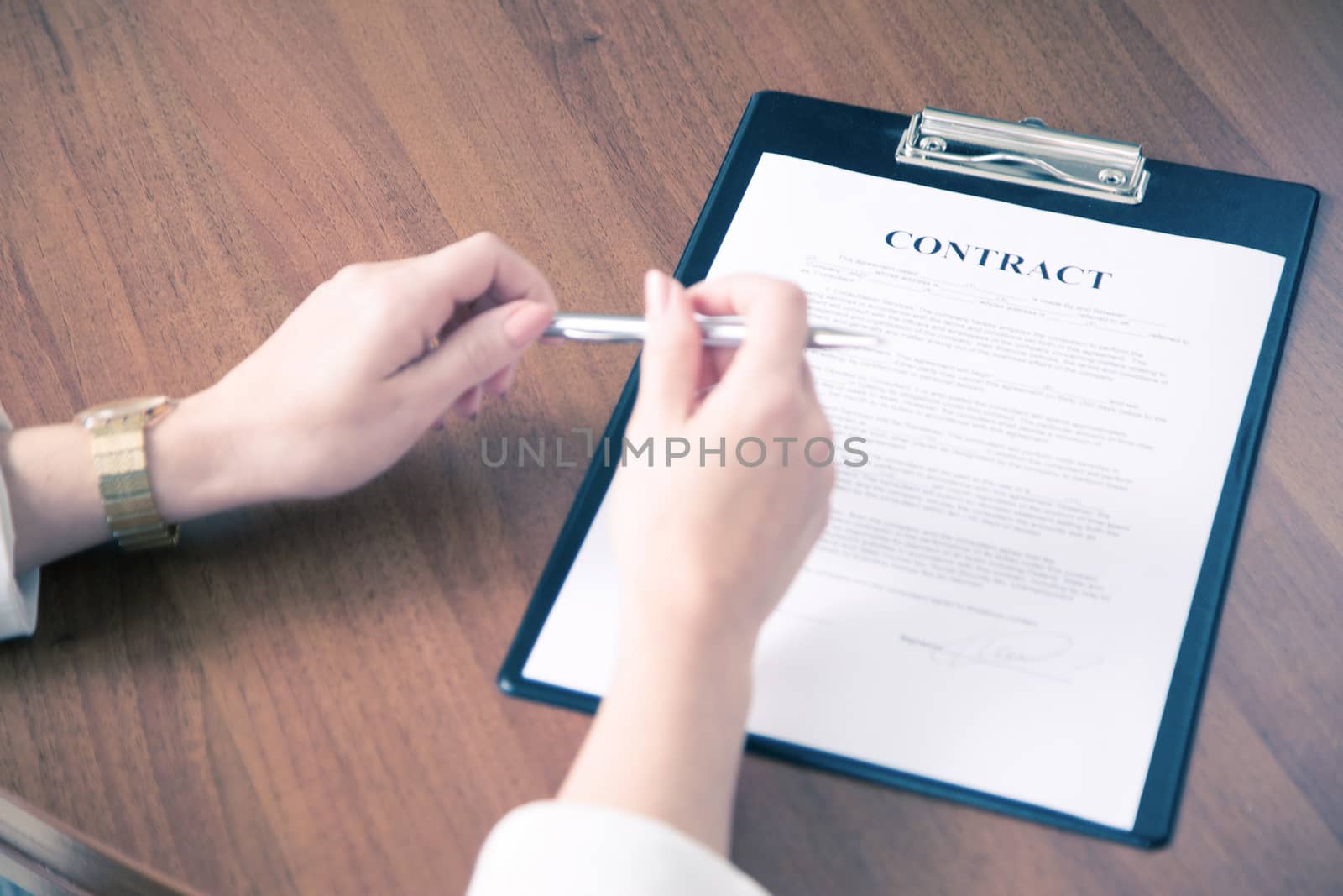 Close-up of business woman keeping hands on contract