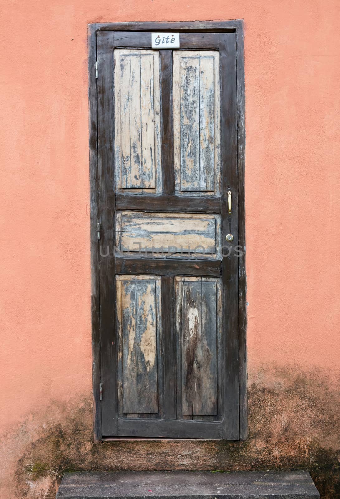 Simple door in an orange wall, fresh paint needed