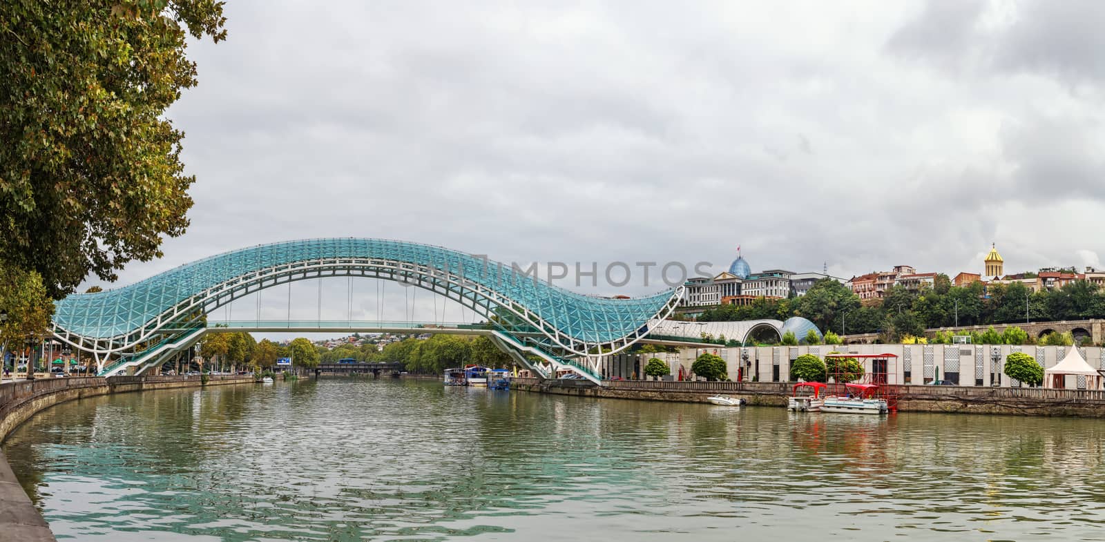 Panoramic view of Kura river with bridge of Peace in Tbilisi, Georgia