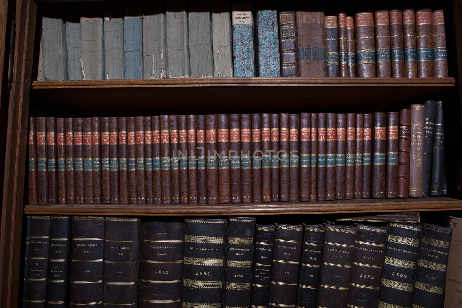 Old books in a wooden row library