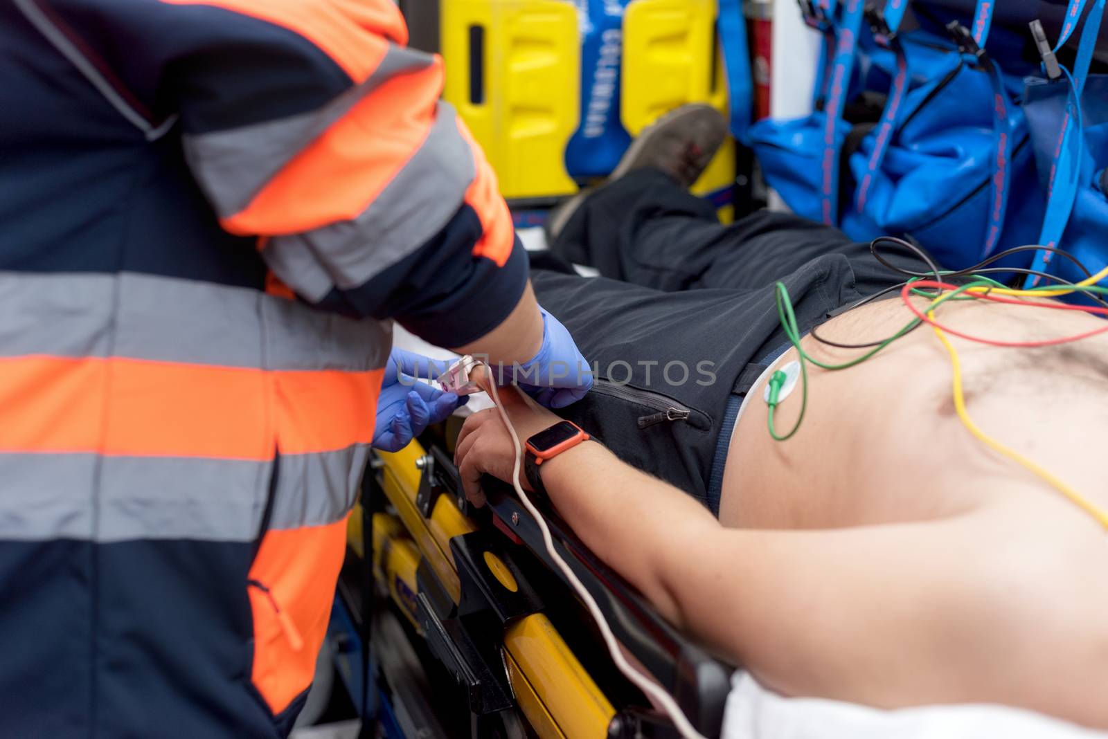 Emergency doctor checking pulse of a patient in the ambulance