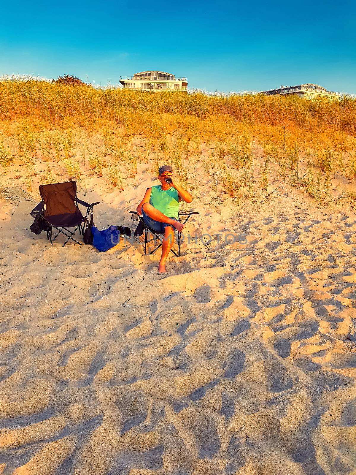 Man is sitting on a beach chair by JFsPic