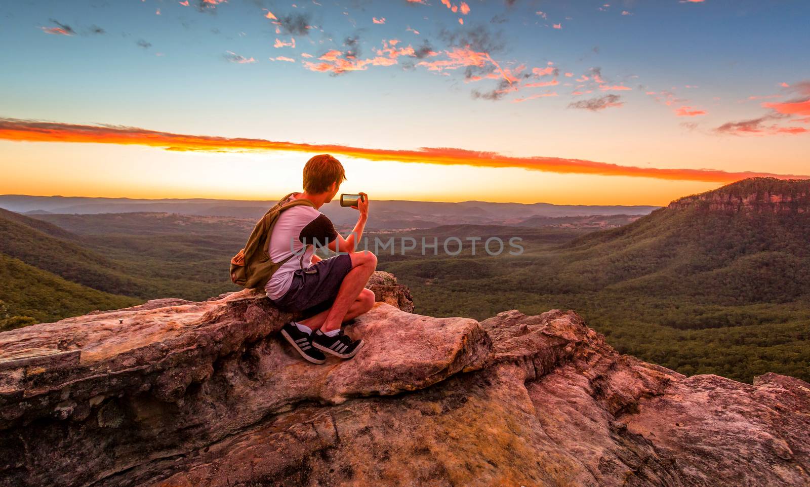 Hiker or tourist taking photos of the most unusual sunset in Blue Mountains Australia