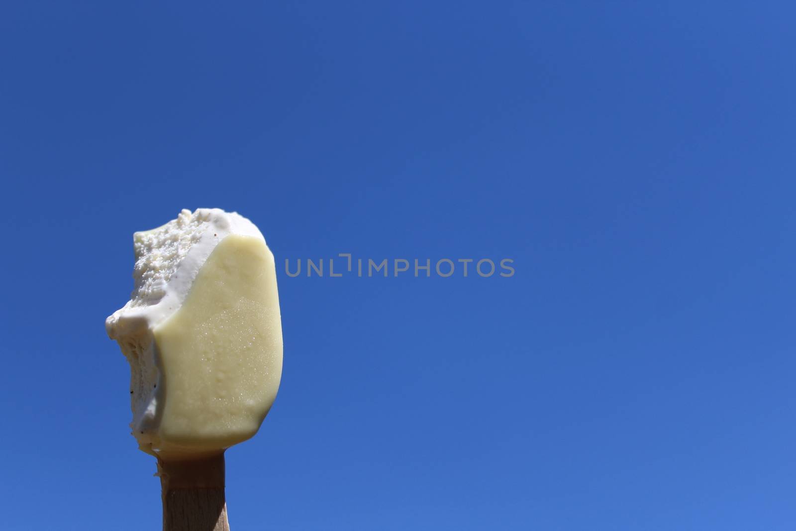 The picture ice cream on a stick and the blue sky.