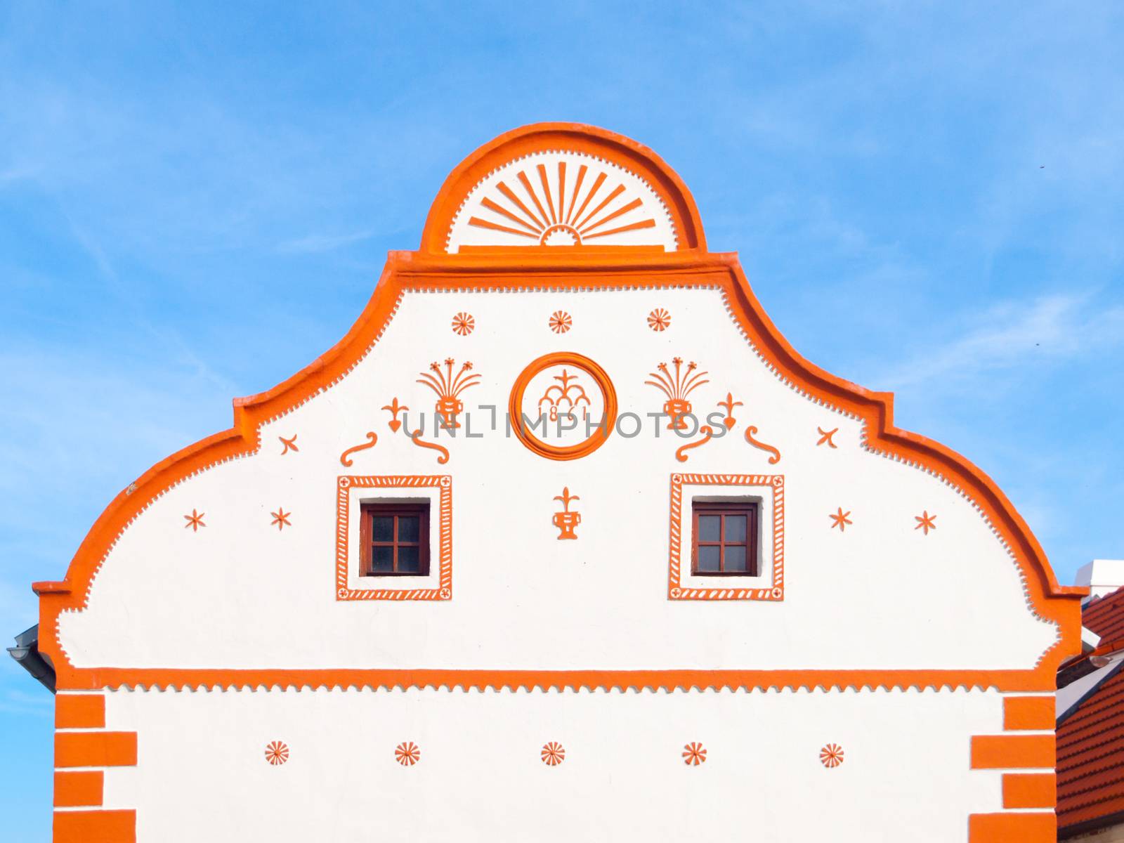 Picturesque gable of old house in Holasovice, small rural village with rustic baroque architecture. Southern Bohemia, Czech Republic. UNESCO heritage site by pyty