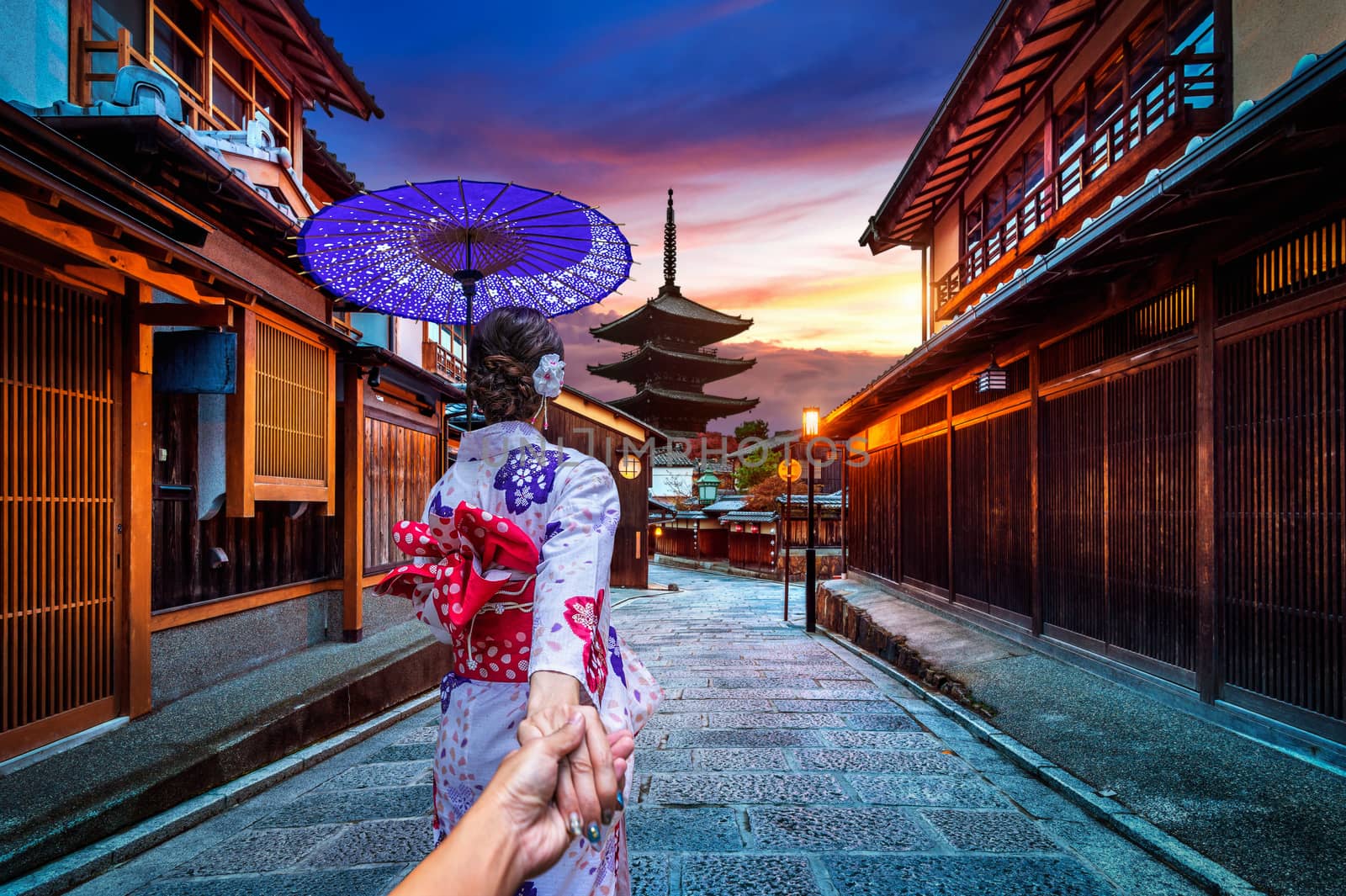 woman wearing japanese traditional kimono holding man's hand and leading him to Yasaka Pagoda and Sannen Zaka Street in Kyoto, Japan. by gutarphotoghaphy