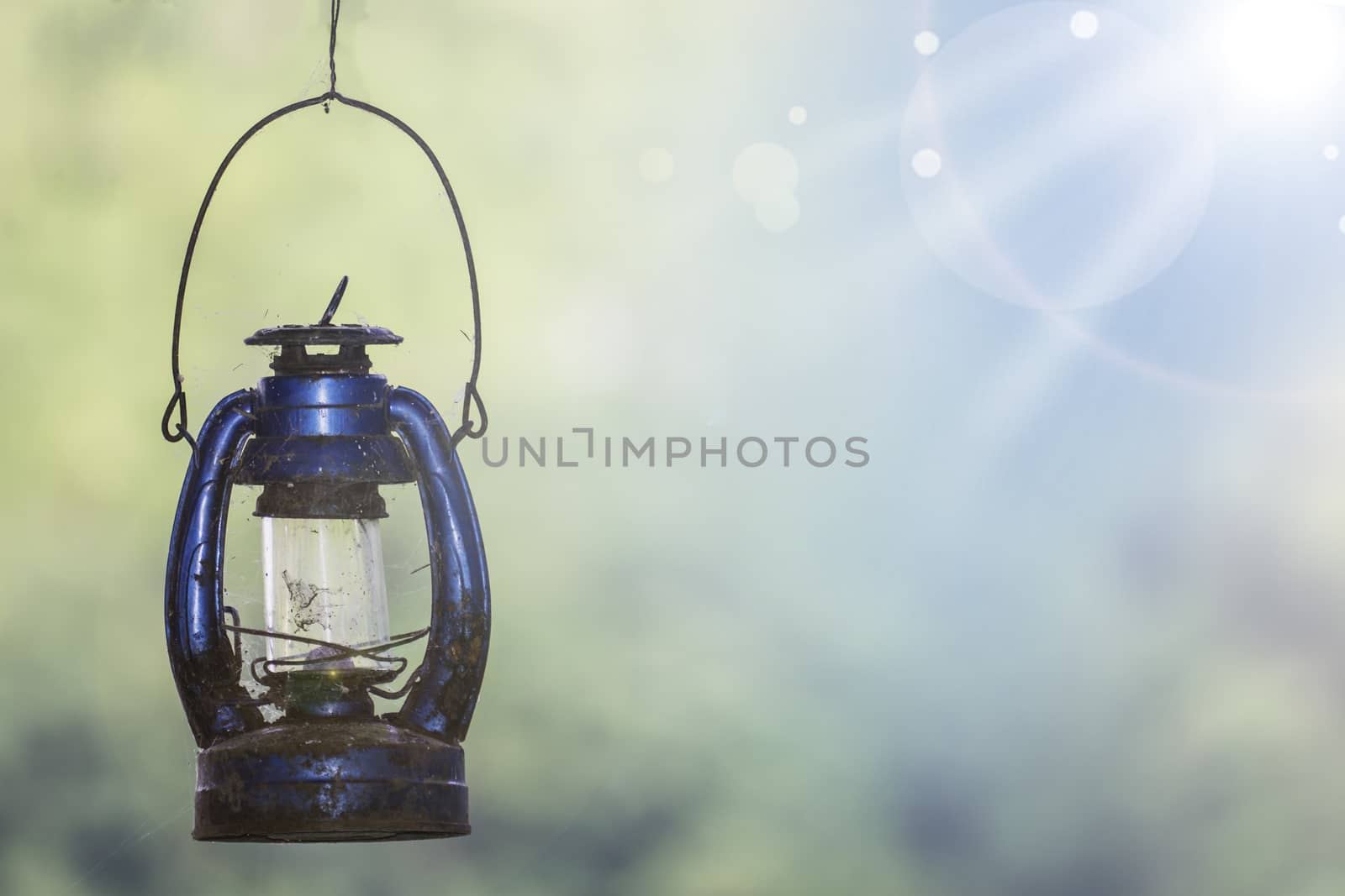 Old Rustic Kerosene Lamp, Old Oil Lamp with Spider Web Isolated on Natural Background