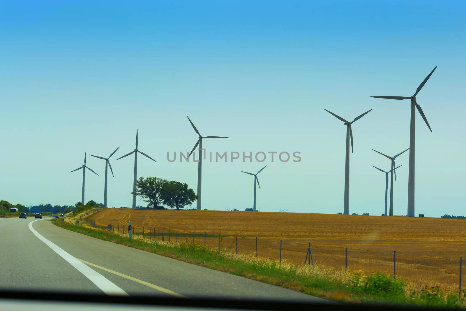 Sustainable green energy. Electric windmill generators in the sunrise