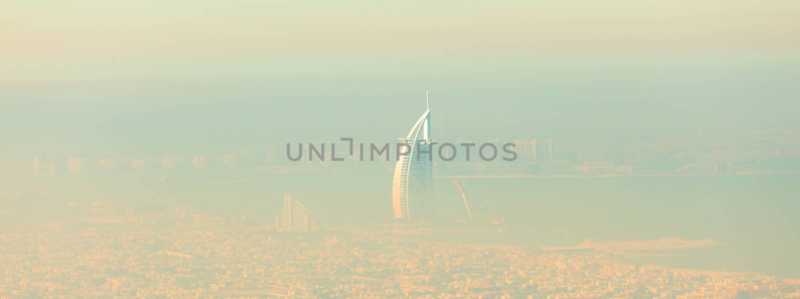 Skyline of Dubai beachfront with Burj Al Arab hotel on Jumeirah beach seen from Burj Khalifa viewpoint. by kasto