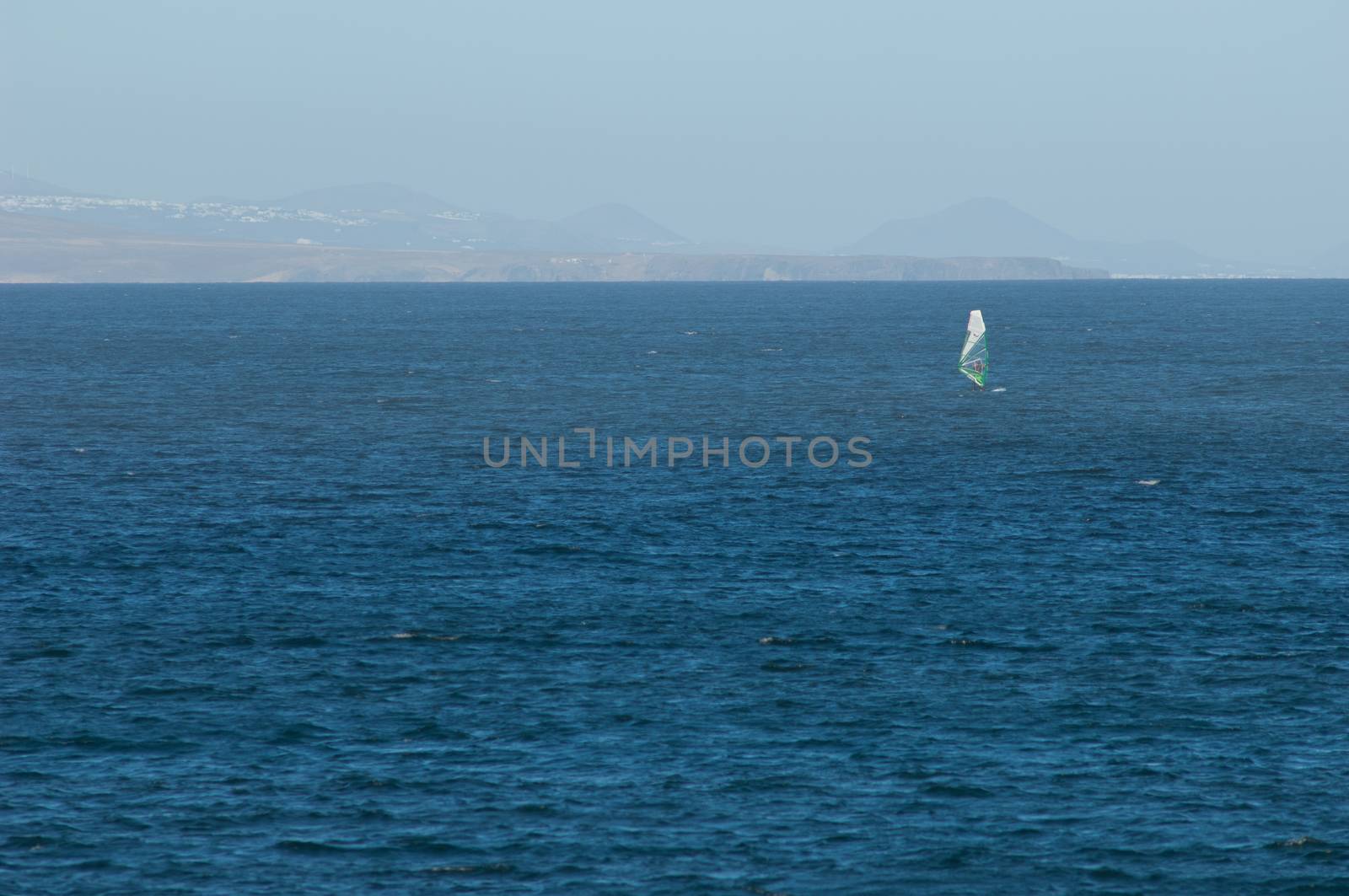 Windsurfer and island of Lanzarote (south) in the background. by VictorSuarez