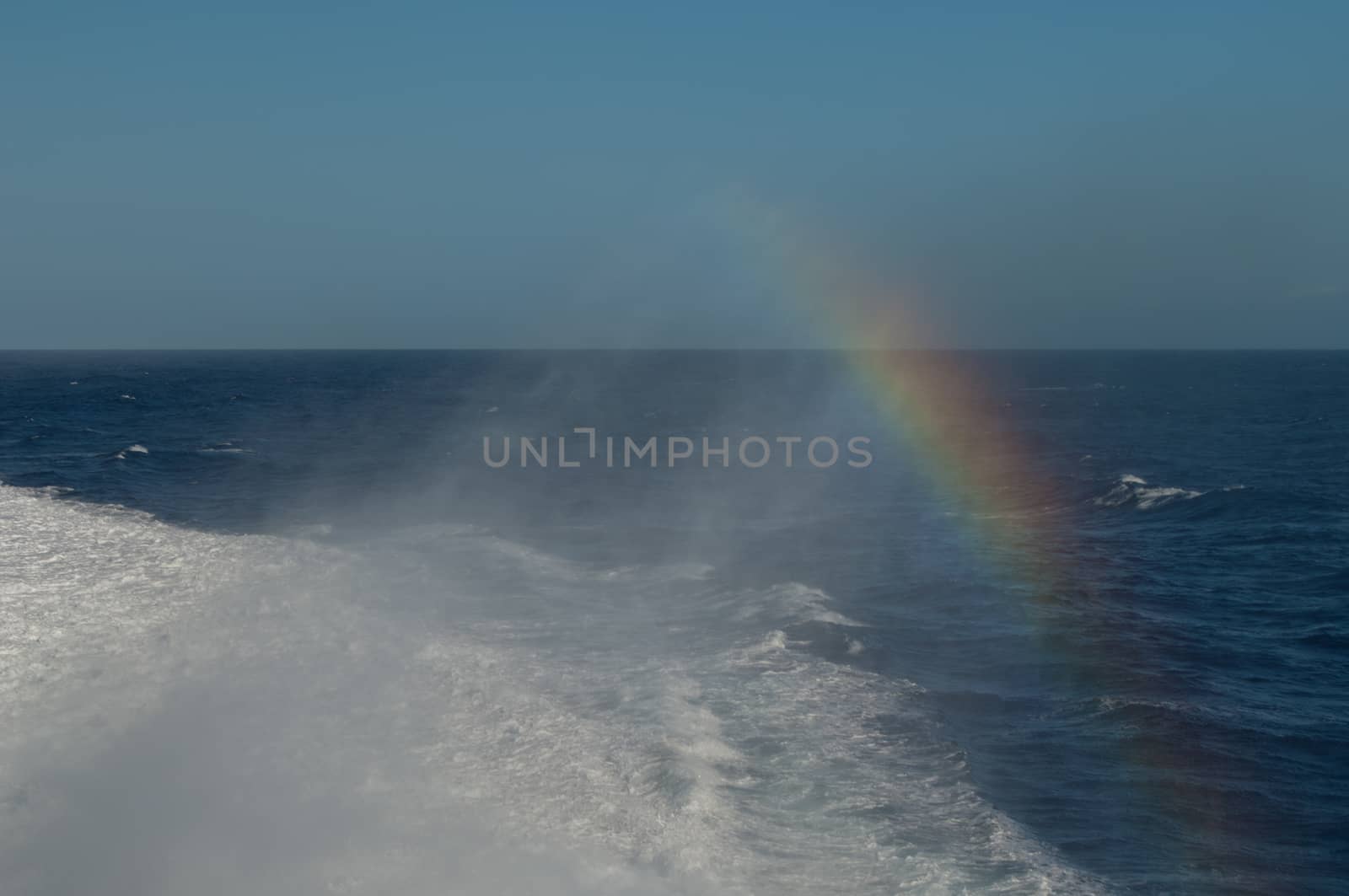 Wake and rainbow left by a ship. by VictorSuarez