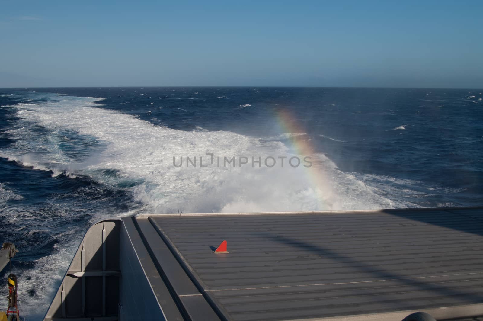 Back of a ship, wake and rainbow. by VictorSuarez