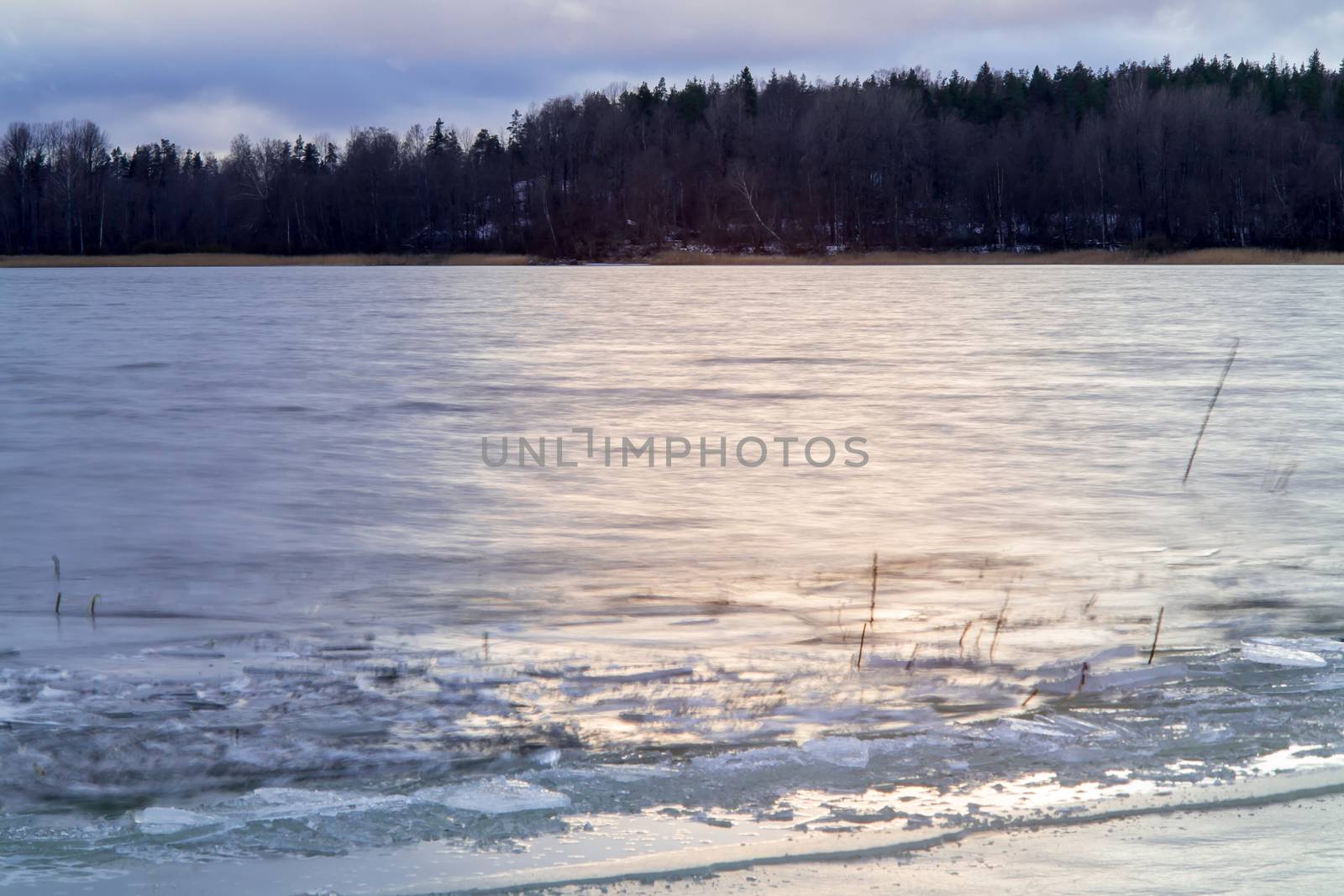 first ice on the lake in late autumn. Winter Coming Landscape.