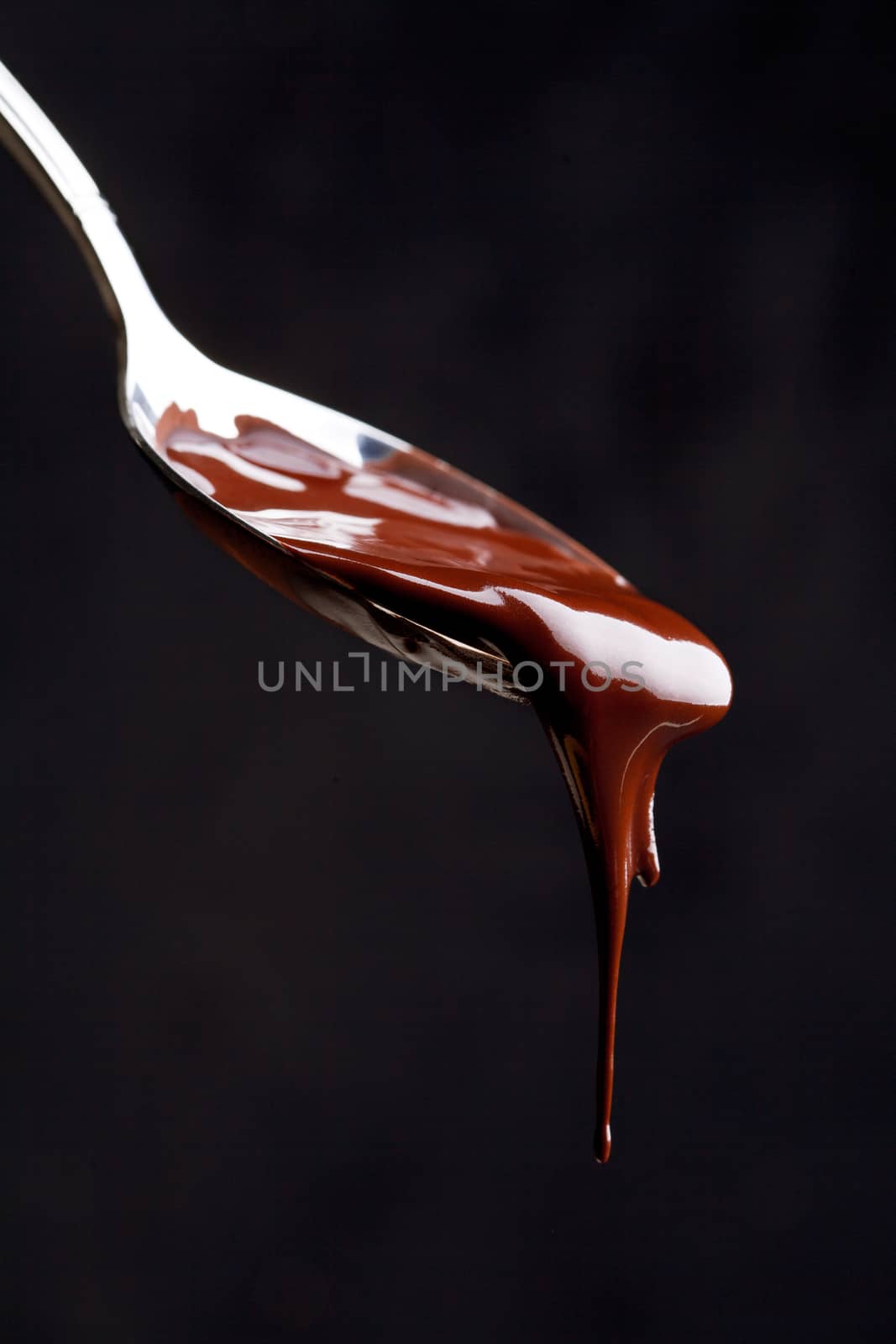 Close Up Of A Spoon Full Of Chocolate by mpessaris