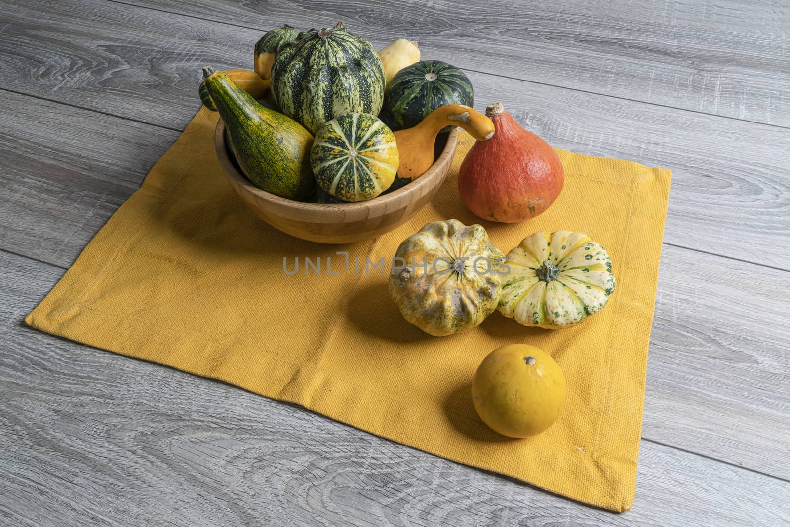 Some small pumpkins  on a wooden table in the autumn