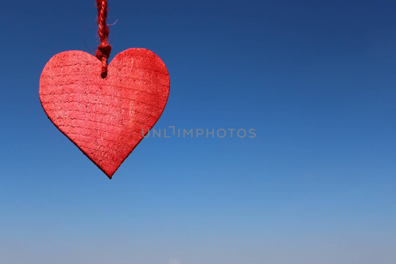 The picture shows a red heart on the blue sky.