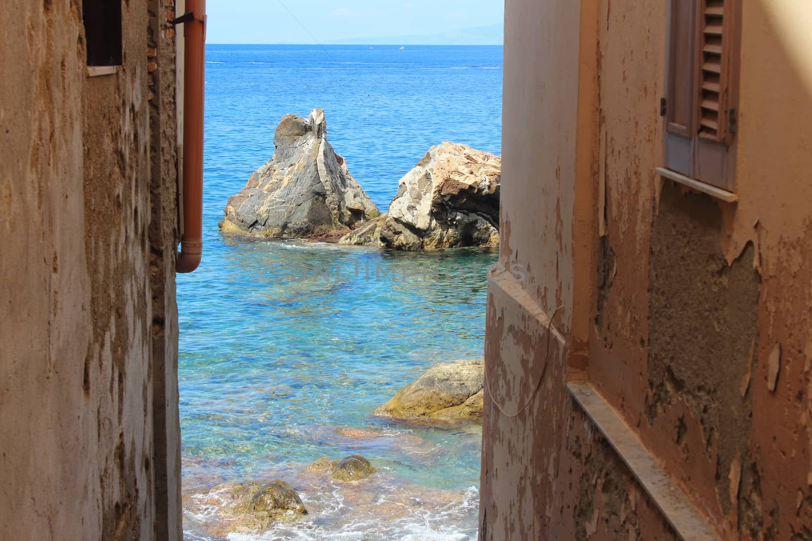 seascape,sea with rocks seen through the buildings of Scilla,Calabria