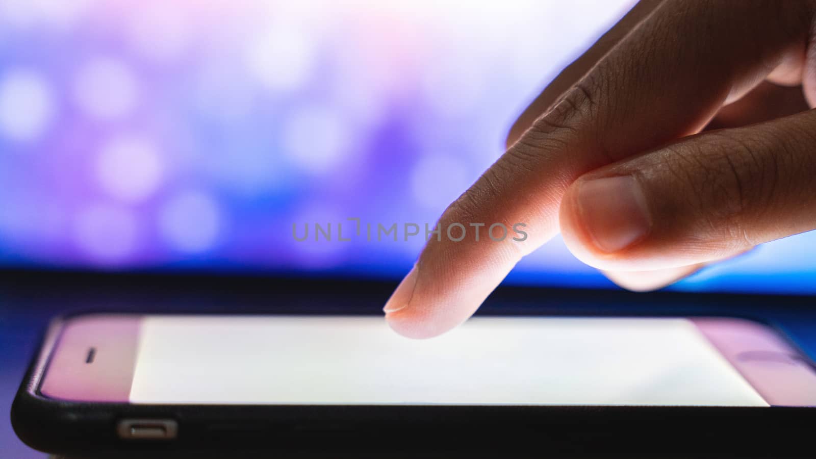 Close up finger touching smart phone.