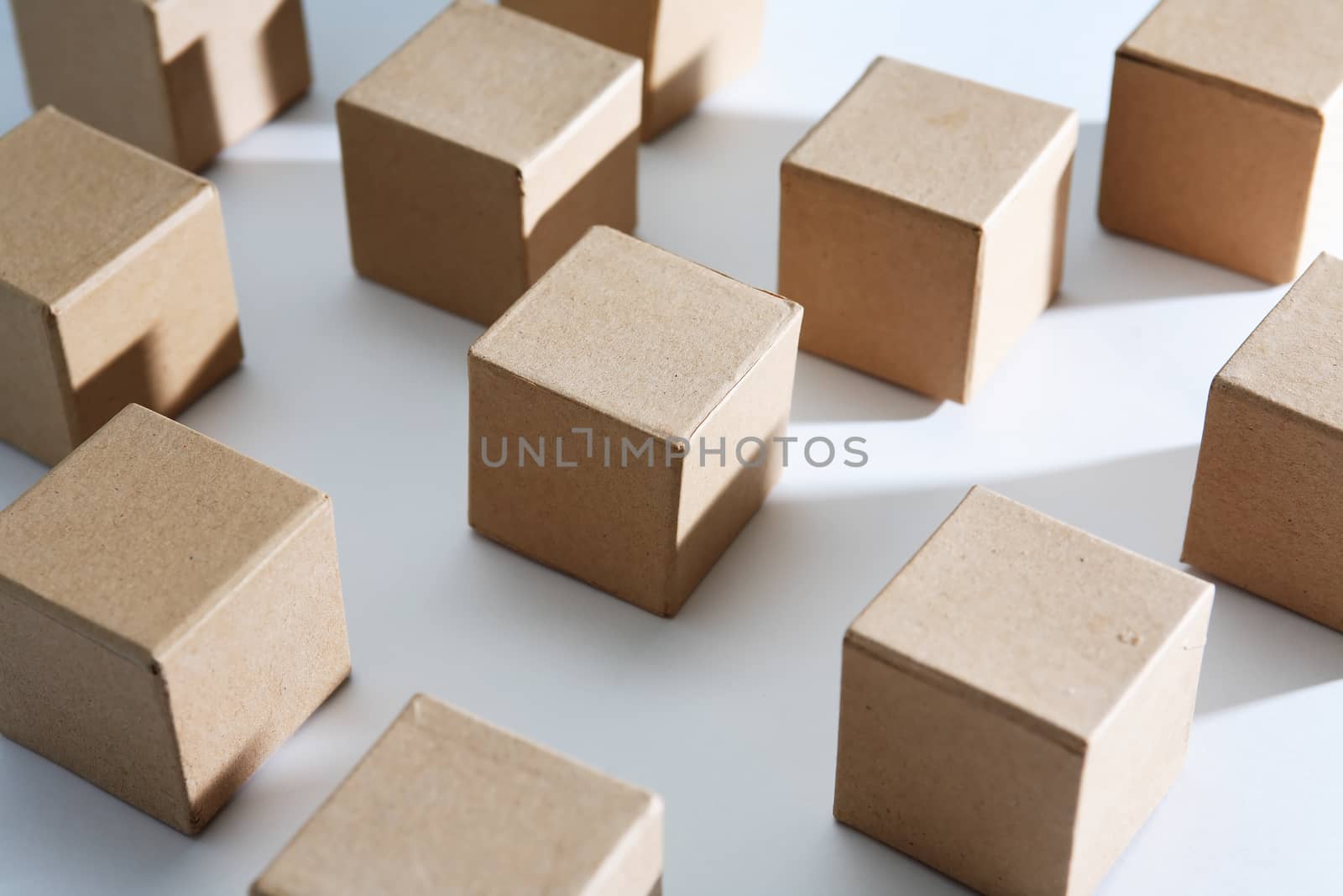 Set of cardboard cubes on white background with light and shadows